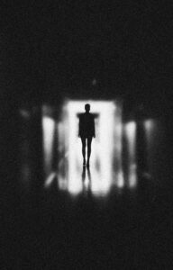 man in dark hallway