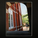 a photograph of a building through an archway