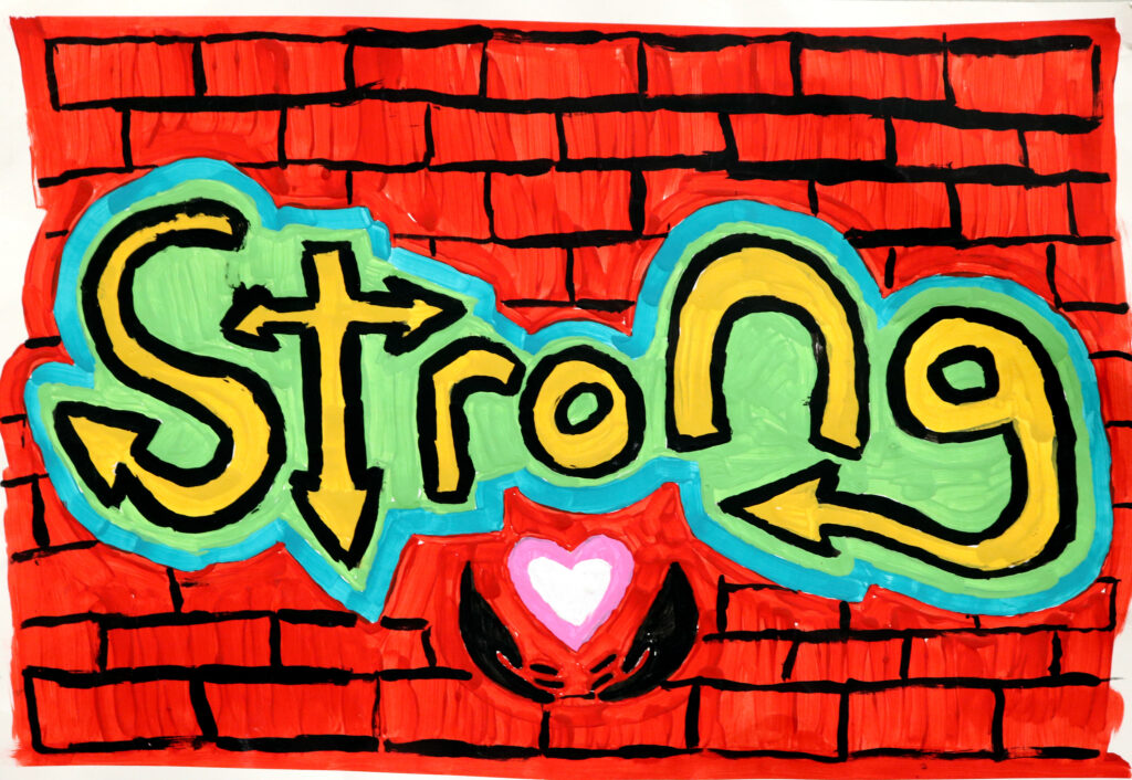 stylized version of the word 'strong' painted on a brick wall